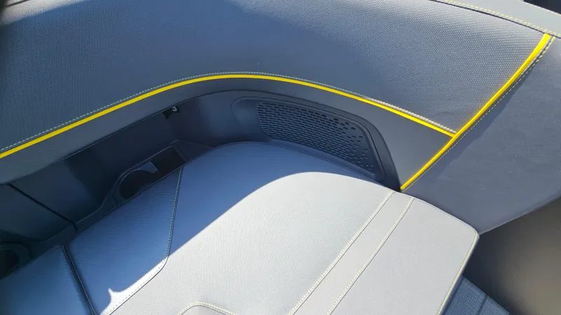 Slide: The Image of 2025 Manitou 24' Explore MAX interior with sleek gray upholstery and yellow accents. - 33