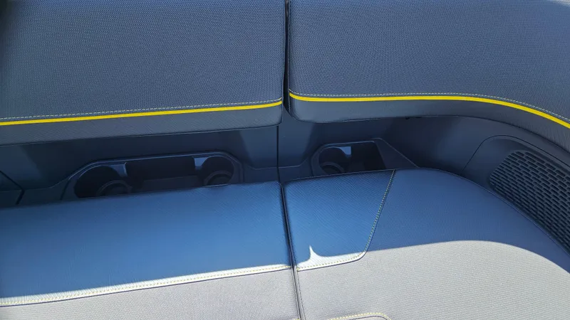 Slide: The Image of 2025 Manitou 24' Explore MAX Deck seating with blue upholstery and yellow accents. - 34