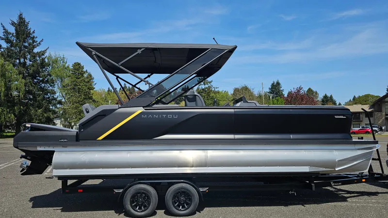Slide: The Image of 2025 Manitou 24' Explore MAX Deck Navigator with 150hp Rotax Stealth Motor on trailer. - 4