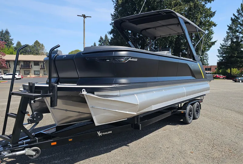 Slide: The Image of 2025 Manitou 24' Explore MAX Deck Navigator with 150hp Rotax Stealth Motor on trailer. - 9