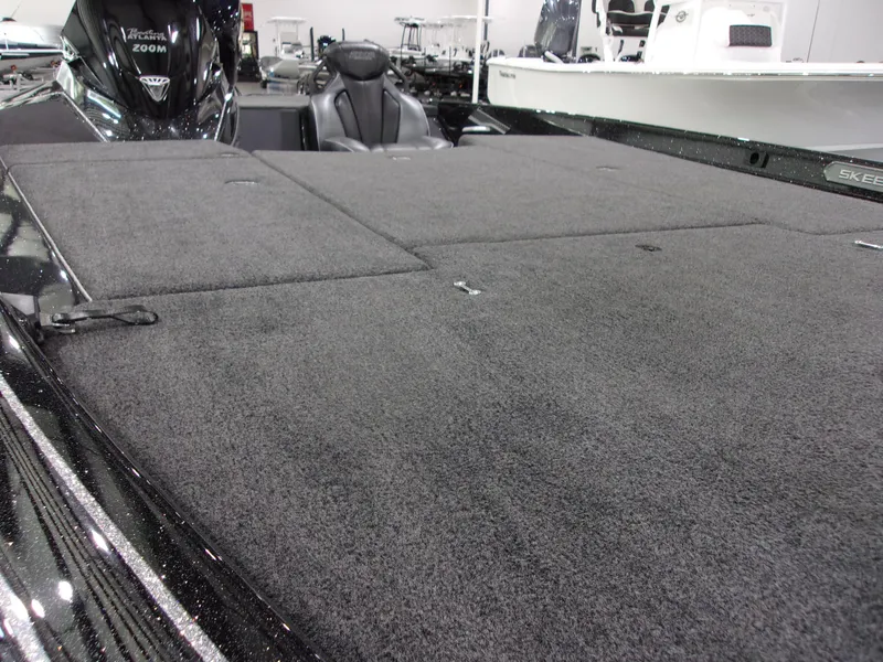 Slide: The Image of 2025 Skeeter FXR-20 Pro boat deck with carpeted surface and seating area. - 16