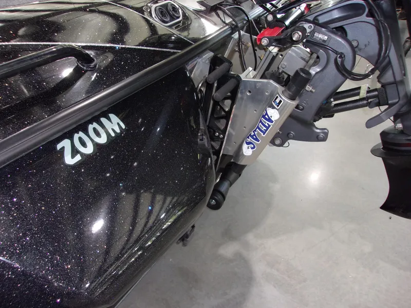 Slide: The Image of 2025 Skeeter FXR-20 Pro boat with shiny black finish and visible motor components. - 5