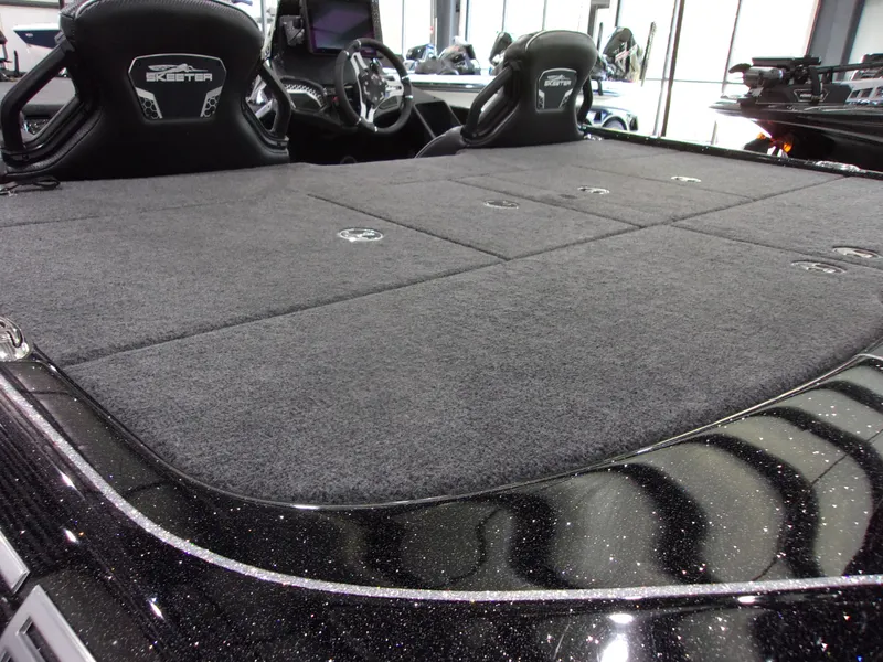 Slide: The Image of 2025 Skeeter FXR-20 Pro boat interior with spacious carpeted deck and sleek design. - 6