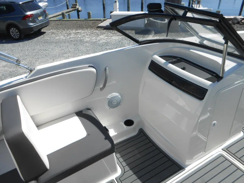 Slide: The Image of 2022 Bayliner VR4 Bowrider OB interior with seating and dashboard, dockside view. - 11