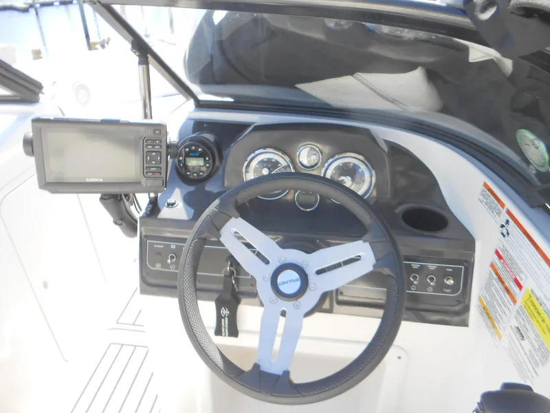 Slide: The Image of 2022 Bayliner VR4 Bowrider OB dashboard with steering wheel and navigation system. - 9