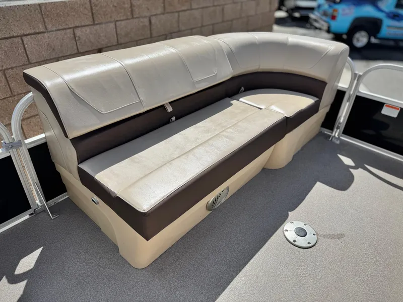 Slide: The Image of 2018 Sun Tracker Party Barge 22 DLX seating area with beige and brown upholstery. - 10