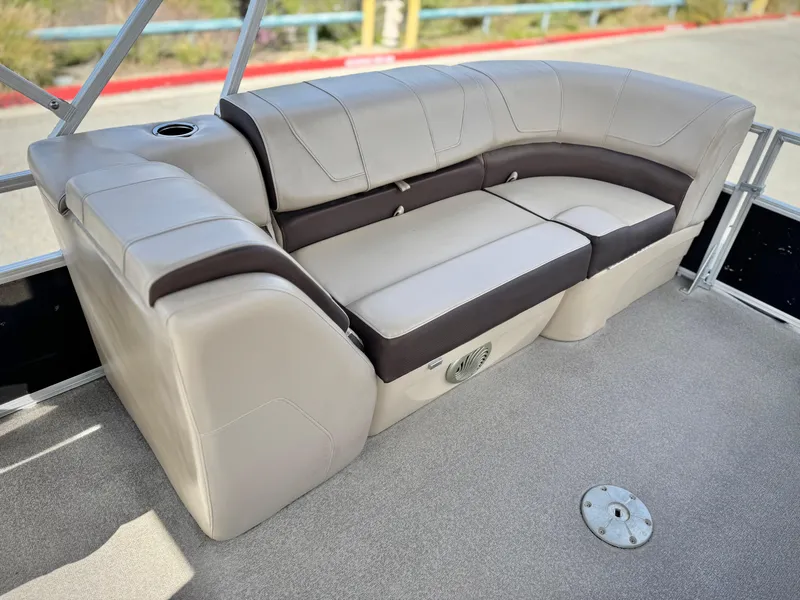 Slide: The Image of 2018 Sun Tracker Party Barge 22 DLX seating area with beige and brown upholstery. - 15