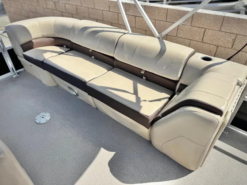 Slide: The Image of 2018 Sun Tracker Party Barge 22 DLX pontoon boat seating, beige and brown upholstery, spacious layout. - 16