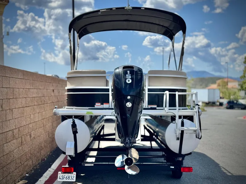 Slide: The Image of 2018 Sun Tracker Party Barge 22 DLX pontoon boat with 150 HP engine, parked outdoors. - 5