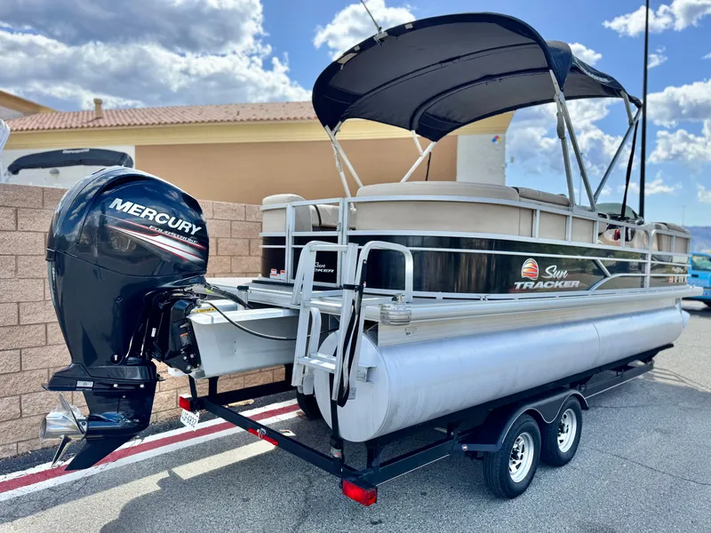 Slide: The Image of 2018 Sun Tracker Party Barge 22 DLX pontoon boat with Mercury outboard motor on trailer. - 6