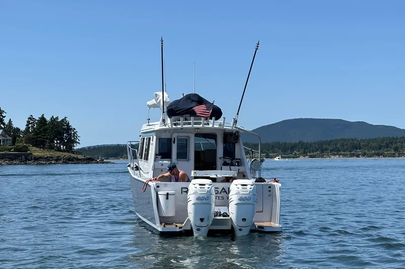 Slide: The Image of 2020 Coastal Craft 33 ProFish boat on water, scenic background, clear sky. - 12