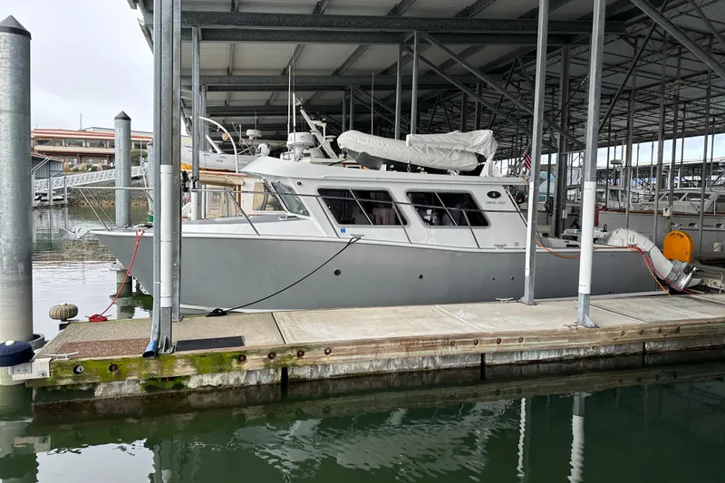 Slide: The Image of 2020 Coastal Craft 33 ProFish docked in a covered marina. - 13