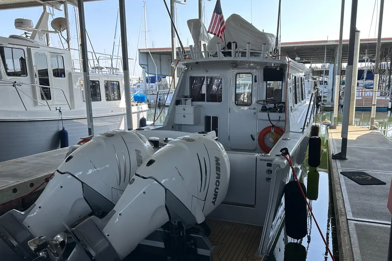 Slide: The Image of 2020 Coastal Craft 33 ProFish boat docked with twin Mercury outboard engines. - 14