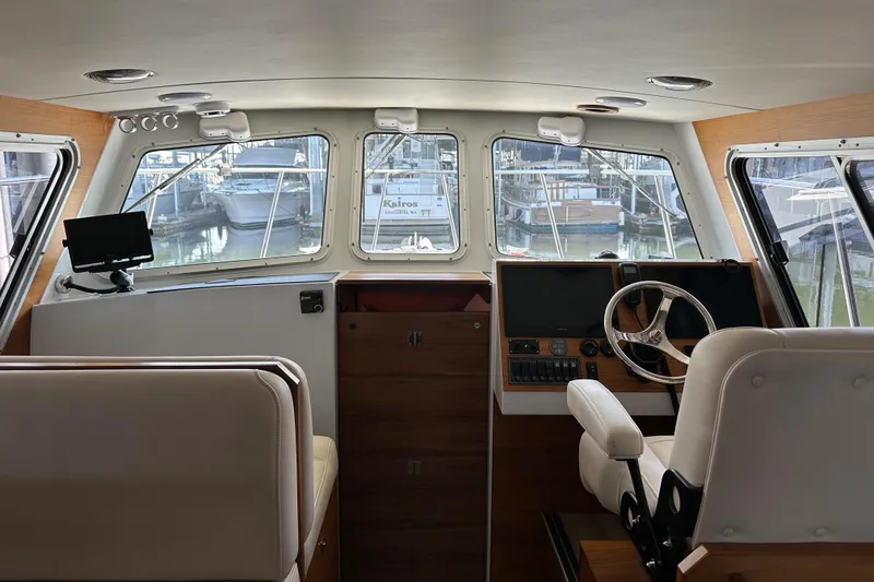Slide: The Image of Interior view of 2020 Coastal Craft 33 ProFish boat cockpit with steering wheel and navigation equipment. - 29