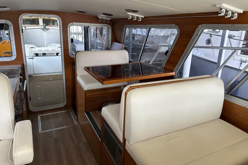 Slide: The Image of Interior of 2020 Coastal Craft 33 ProFish with wood accents and white seating. - 32