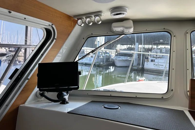 Slide: The Image of Interior view of 2020 Coastal Craft 33 ProFish boat with marina in background. - 37