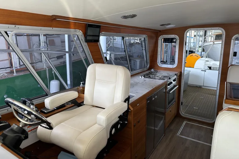 Slide: The Image of Interior of 2020 Coastal Craft 33 ProFish boat with helm, kitchen, and seating area. - 39