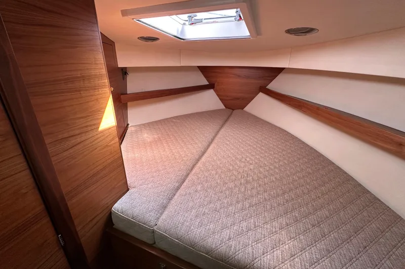 Slide: The Image of 2020 Coastal Craft 33 ProFish cabin interior with cozy bed and wooden accents. - 42