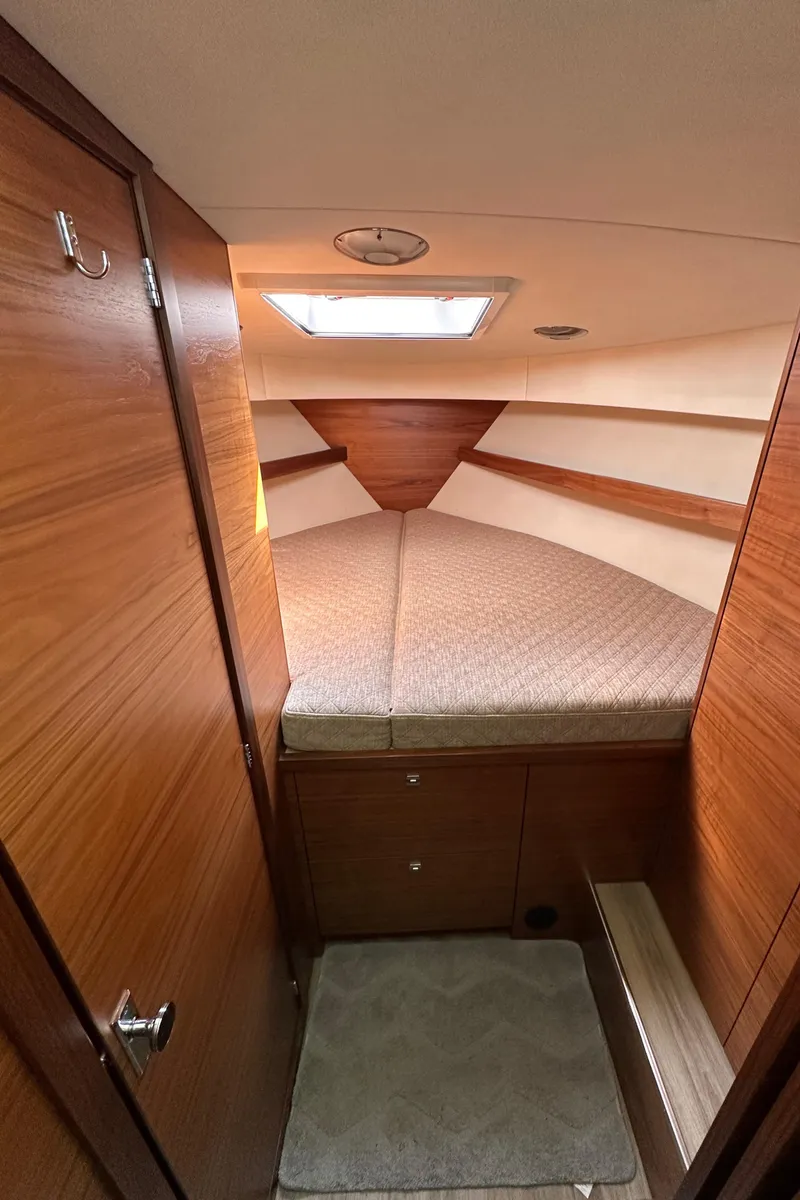 Slide: The Image of 2020 Coastal Craft 33 ProFish cabin interior with wood finish and cozy sleeping area. - 44