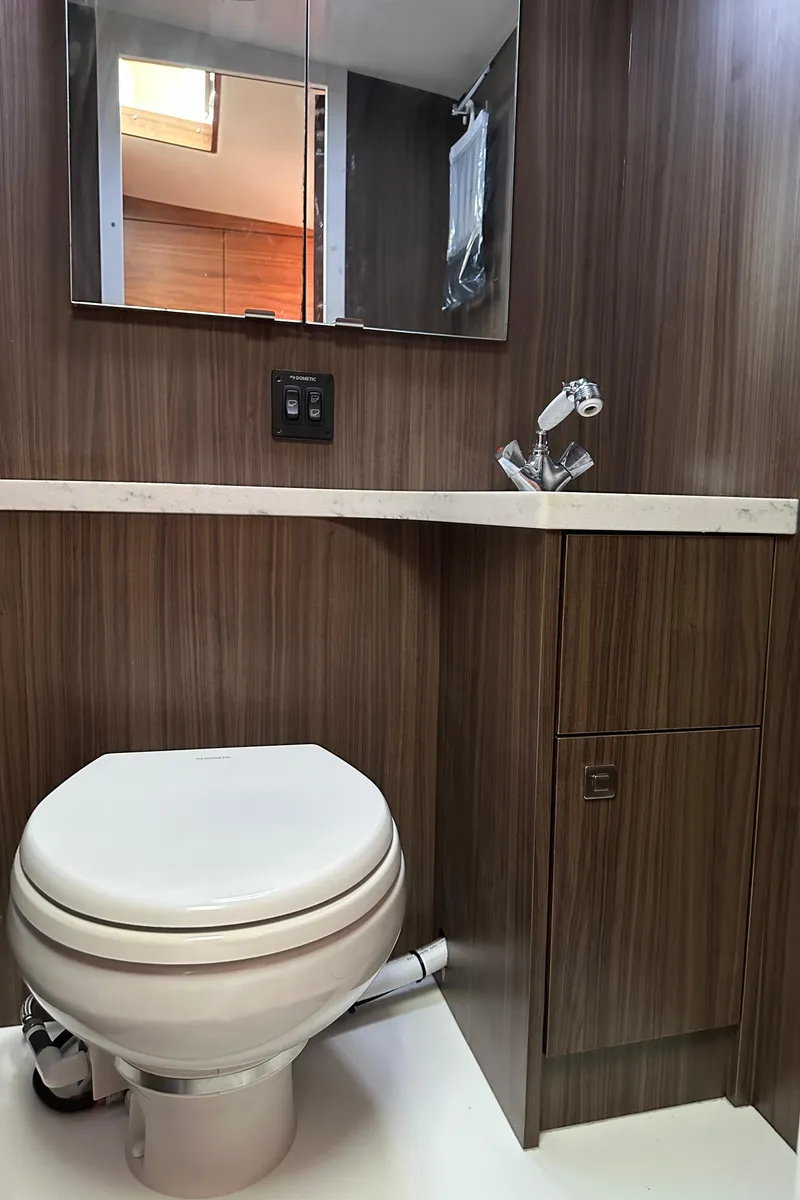 Slide: The Image of 2020 Coastal Craft 33 ProFish bathroom with modern wood paneling and compact fixtures. - 47