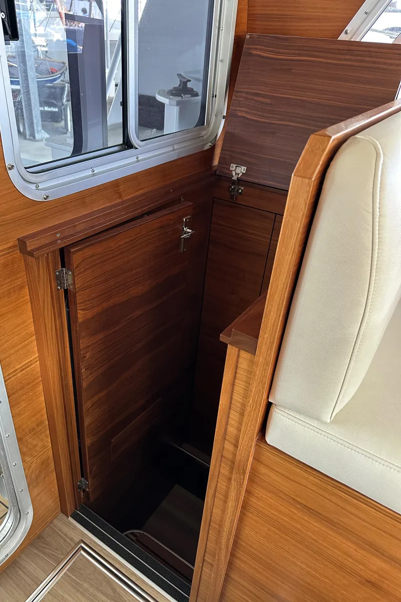 Slide: The Image of Interior view of 2020 Coastal Craft 33 ProFish, featuring wooden cabinetry and seating. - 49