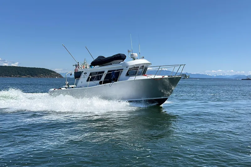 Slide: The Image of 2020 Coastal Craft 33 ProFish cruising on open water under clear blue skies. - 5