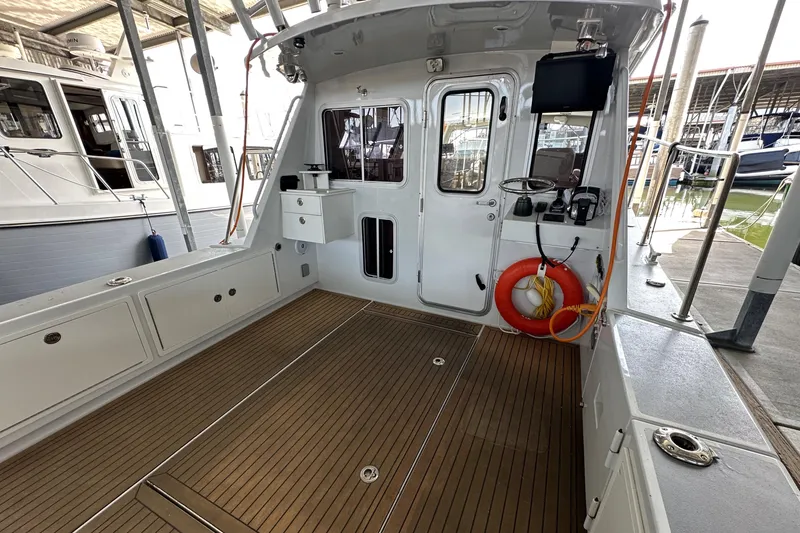 Slide: The Image of 2020 Coastal Craft 33 ProFish boat interior with wooden deck and safety equipment. - 52