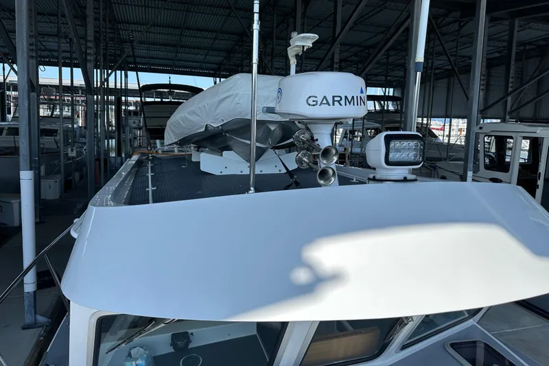 Slide: The Image of 2020 Coastal Craft 33 ProFish boat with Garmin radar in a covered marina. - 57