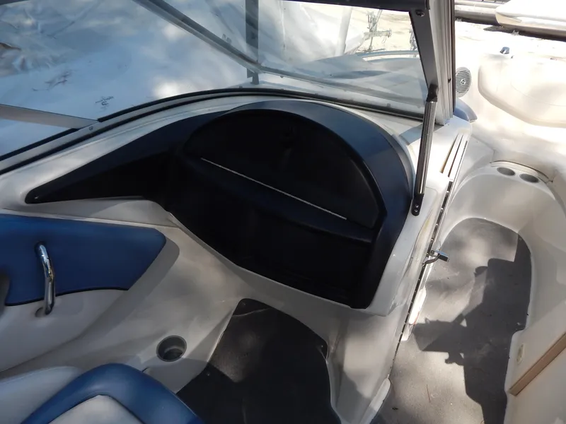 Slide: The Image of Interior view of a 2013 Bayliner 235 Bowrider boat, featuring seating and dashboard. - 11