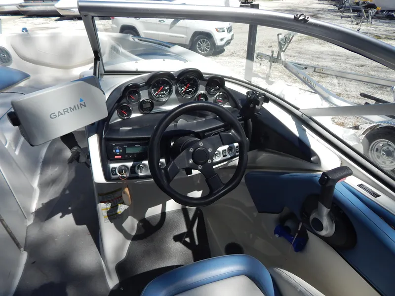 Slide: The Image of 2013 Bayliner 235 Bowrider dashboard with Garmin navigation system and steering wheel. - 13