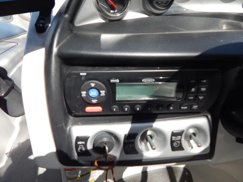 Slide: The Image of Control panel of a 2013 Bayliner 235 Bowrider boat with stereo and switches. - 16