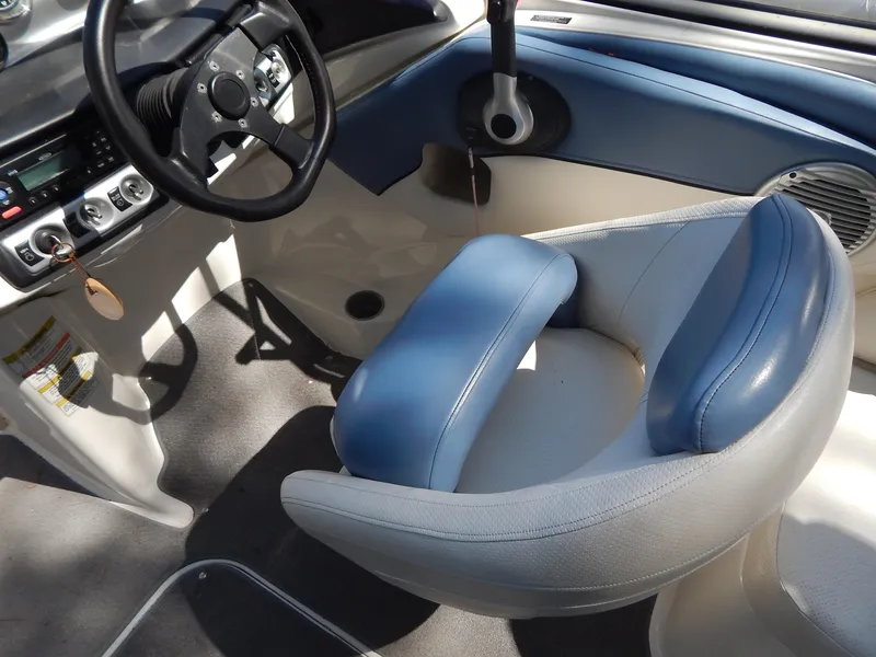 Slide: The Image of Interior of 2013 Bayliner 235 Bowrider boat with blue and white seating. - 18