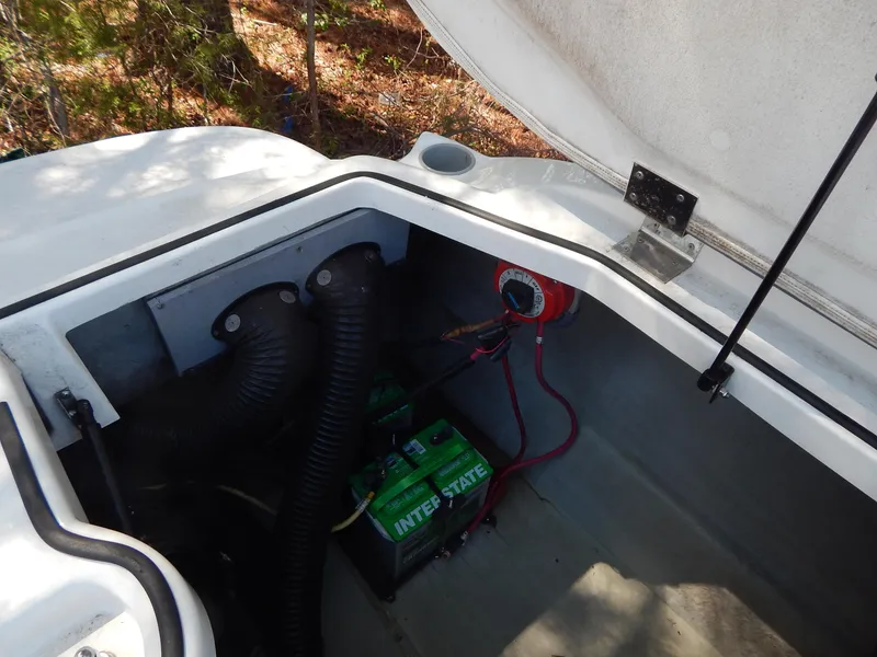 Slide: The Image of 2013 Bayliner 235 Bowrider engine compartment with battery and wiring. - 21