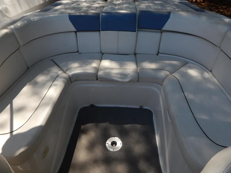 Slide: The Image of 2013 Bayliner 235 Bowrider interior seating with white and blue upholstery. - 22