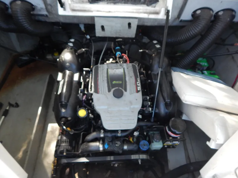 Slide: The Image of Engine compartment of 2013 Bayliner 235 Bowrider boat, showcasing the inboard motor. - 23