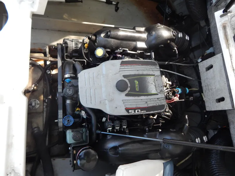 Slide: The Image of 2013 Bayliner 235 Bowrider engine compartment with 5.0 MPI engine. - 24
