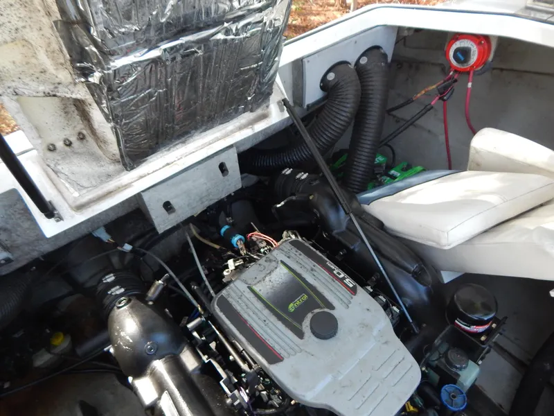 Slide: The Image of Engine compartment of a 2013 Bayliner 235 Bowrider, showing detailed mechanical components. - 25