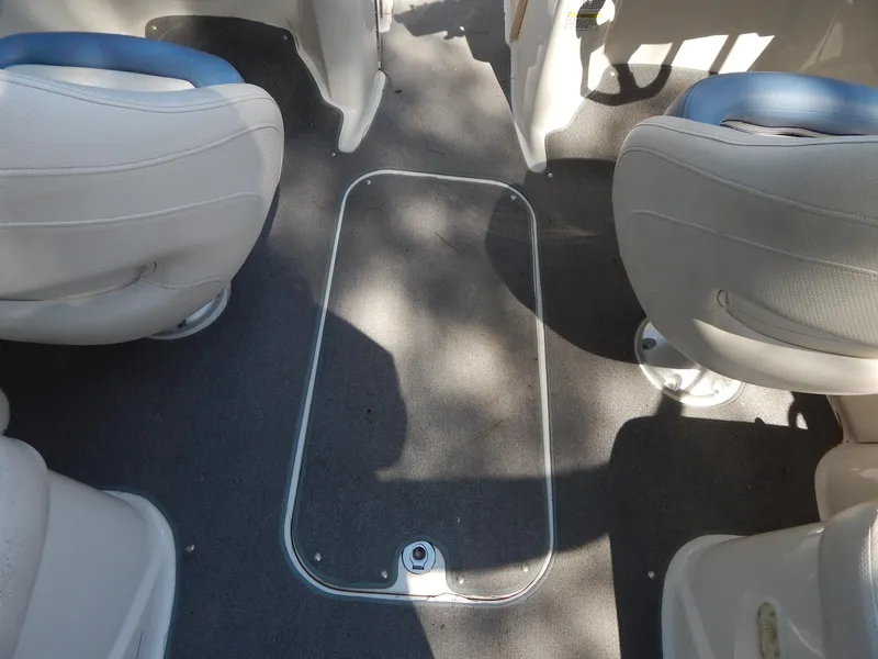 Slide: The Image of 2013 Bayliner 235 Bowrider interior with seating and floor storage compartment. - 26