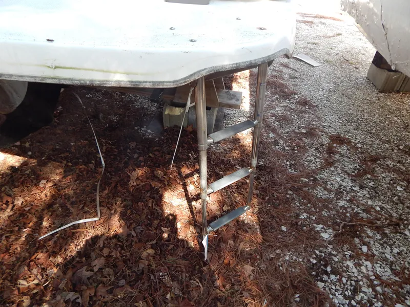 Slide: The Image of 2013 Bayliner 235 Bowrider with ladder on dry leaves and gravel. - 30