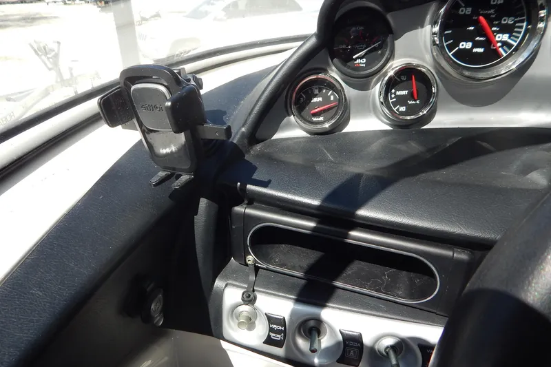 Slide: The Image of Dashboard of 2013 Bayliner 235 Bowrider with gauges and controls. - 35