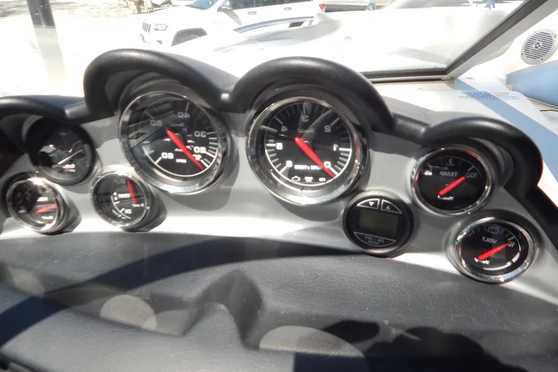Slide: The Image of Dashboard of a 2013 Bayliner 235 Bowrider with multiple gauges and controls. - 36
