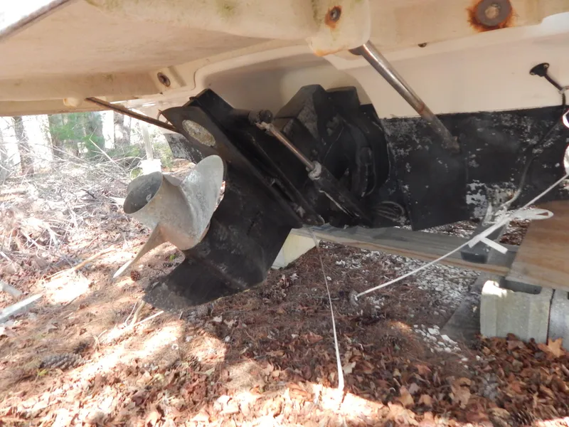 Slide: The Image of 2013 Bayliner 235 Bowrider boat propeller and stern drive in wooded area. - 6