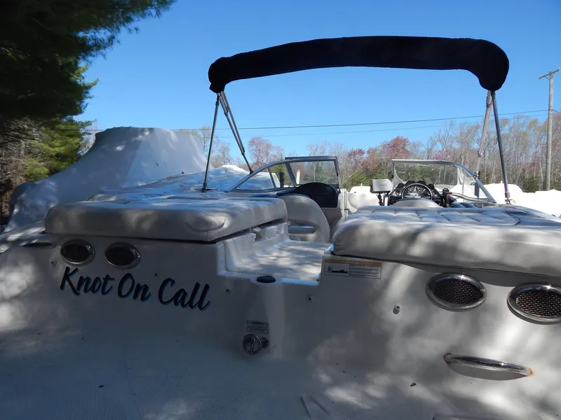 Slide: The Image of 2013 Bayliner 235 Bowrider boat with "Knot On Call" name, docked outdoors. - 8