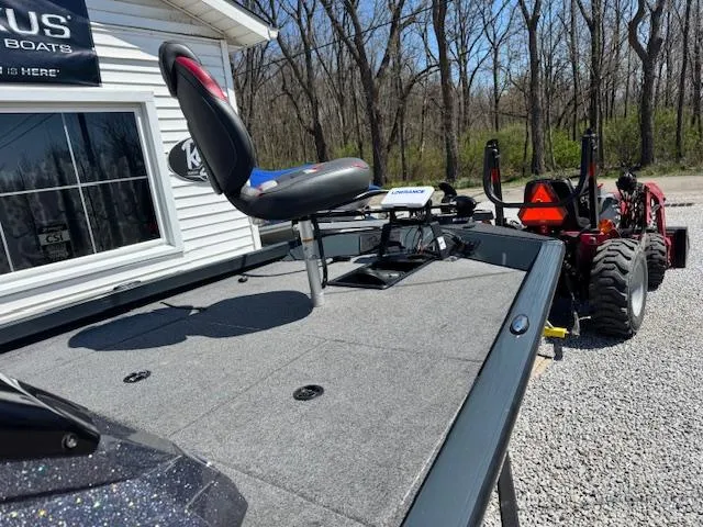 Slide: The Image of 2023 Ranger RT178 boat with elevated seat, parked near a building, surrounded by trees. - 6