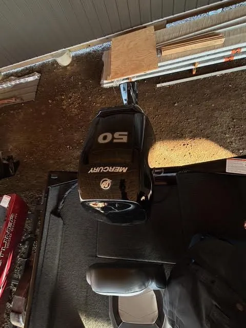 Slide: The Image of 2025 Lowe Skorpion 17 boat with Mercury 50 engine in a garage setting. - 13