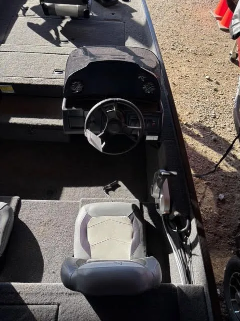 Slide: The Image of 2025 Lowe Skorpion 17 boat interior with steering wheel and seating. - 9