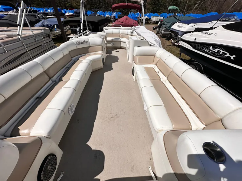 Slide: The Image of 2006 Bentley Pontoons 240 Cruise Pontoon with spacious seating, docked among other boats. - 3