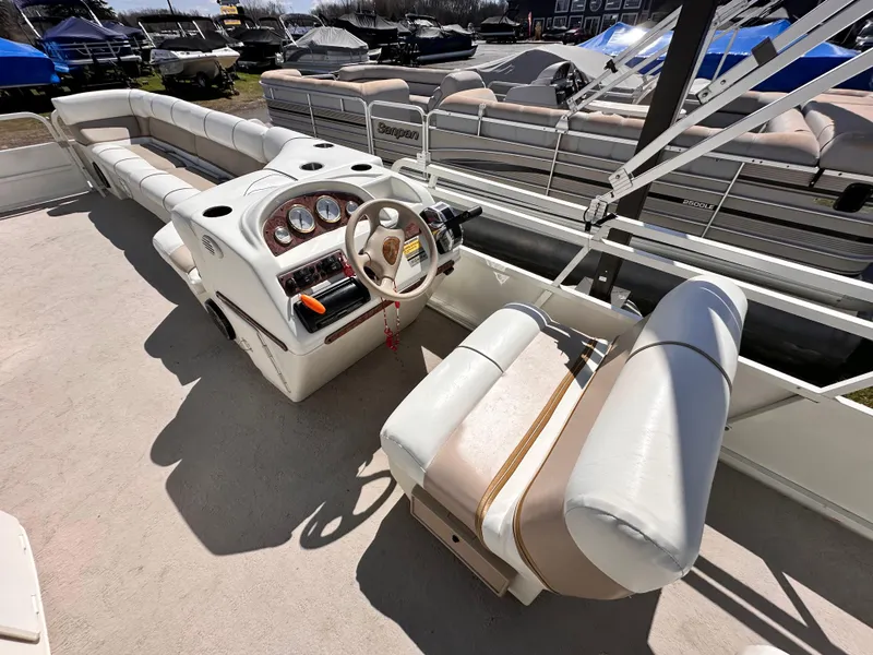Slide: The Image of 2006 Bentley Pontoons 240 Cruise Pontoon with spacious seating and modern dashboard controls. - 7