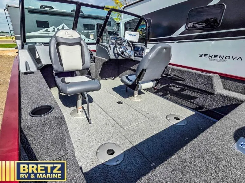 Slide: The Image of Interior of a 2025 Machine Walk Thru FM 1625 WT boat with seating and controls. - 17