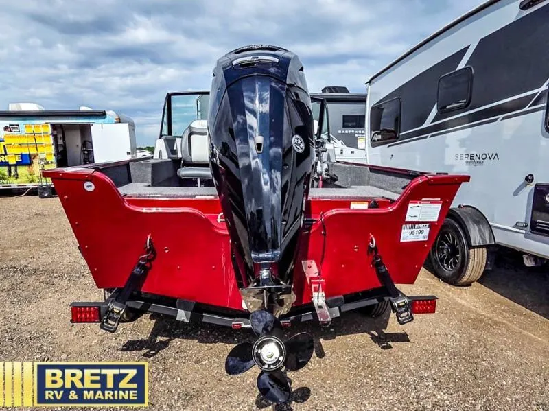 Slide: The Image of Red Machine Walk Thru FM 1625 WT boat with outboard motor, parked at Bretz RV & Marine. - 7